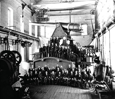 In 1894 Morgan employees gathered proudly to be photographed on this 10-inch Gordon Disappearing Gun Carriage.