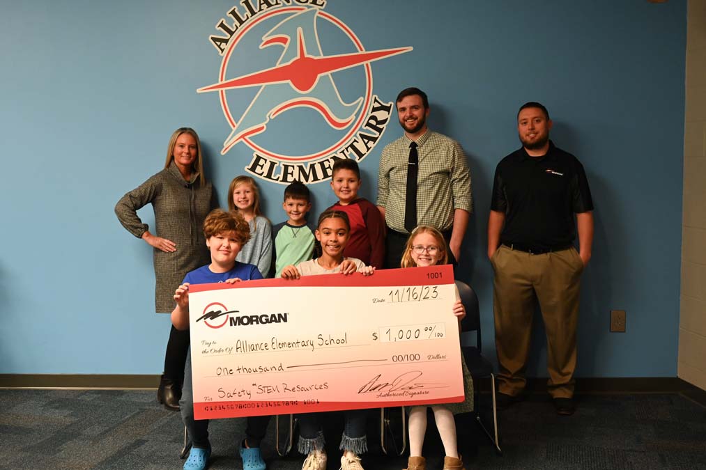 Alliance Elementary School students holding check