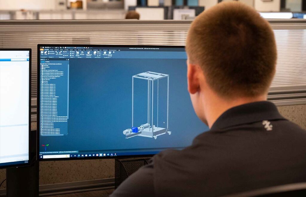 Figure 3 Intern reviewing 3D model for project.