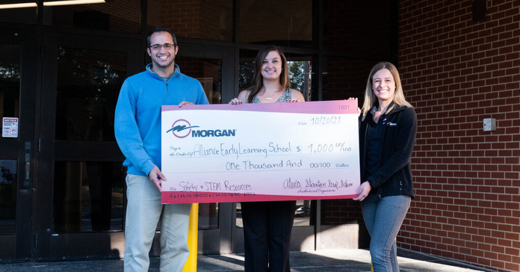Morgan employees presenting a check made to Alliance Elementary Schools