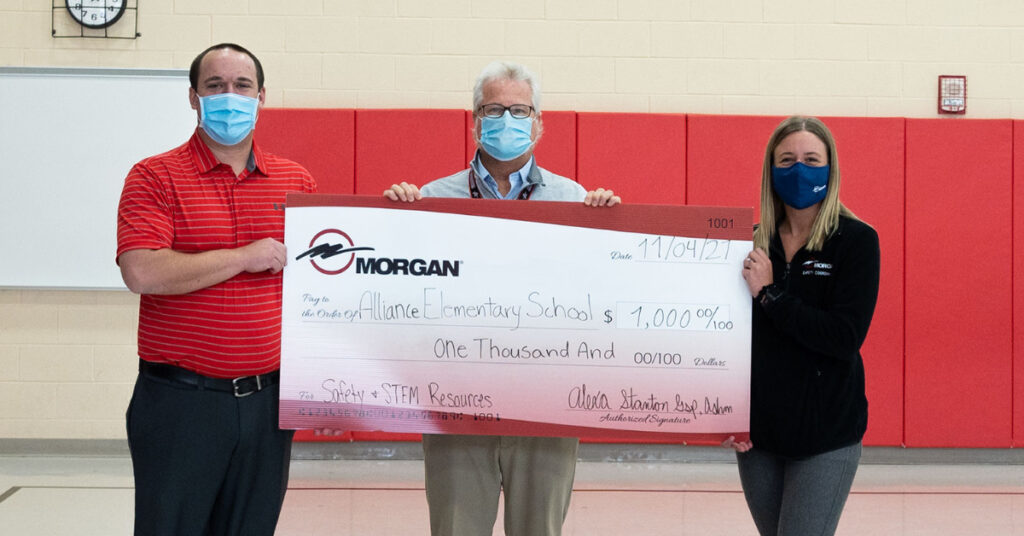 Morgan employees presenting a check made to Alliance Elementary Schools