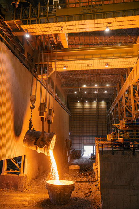 Ladle crane pouring hot molten metal.