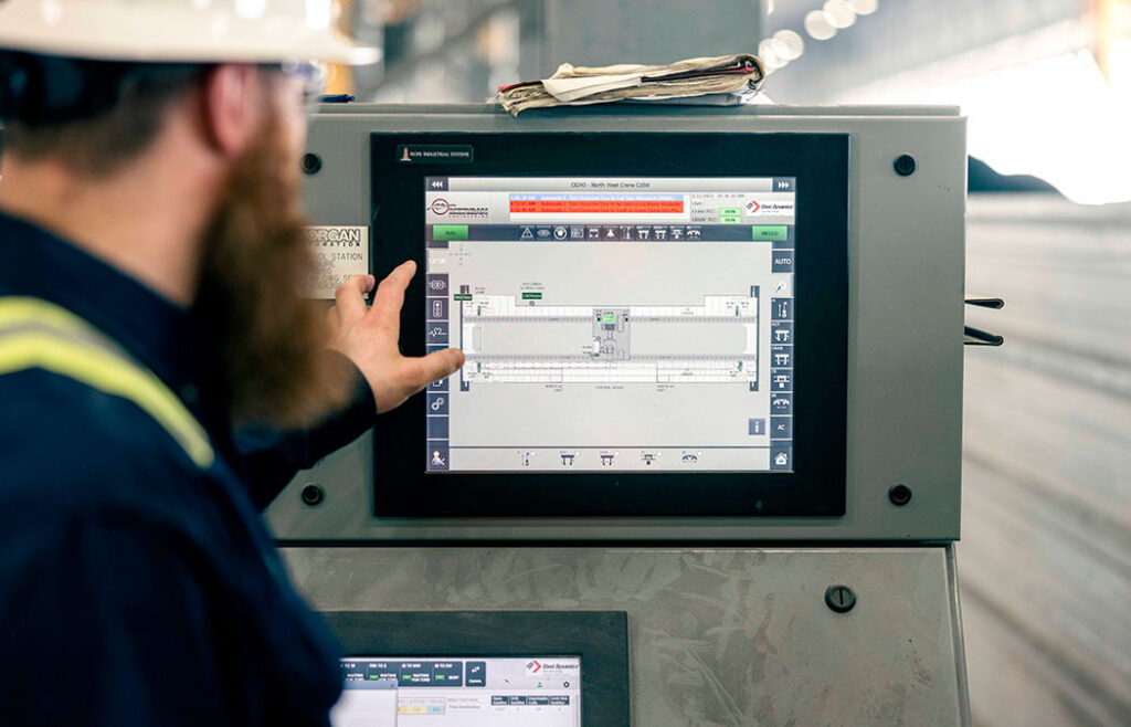 Crane operator troubleshoots an issue on an overhead crane from the Crane Management station.