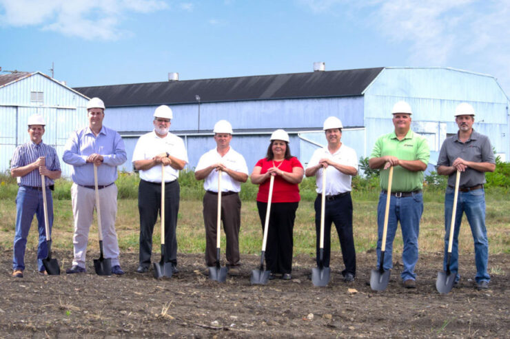 Morgan management staff holding shovels at a groundbreaking ceremony