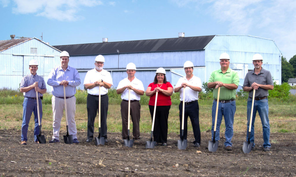 Morgan management staff holding shovels at a groundbreaking ceremony