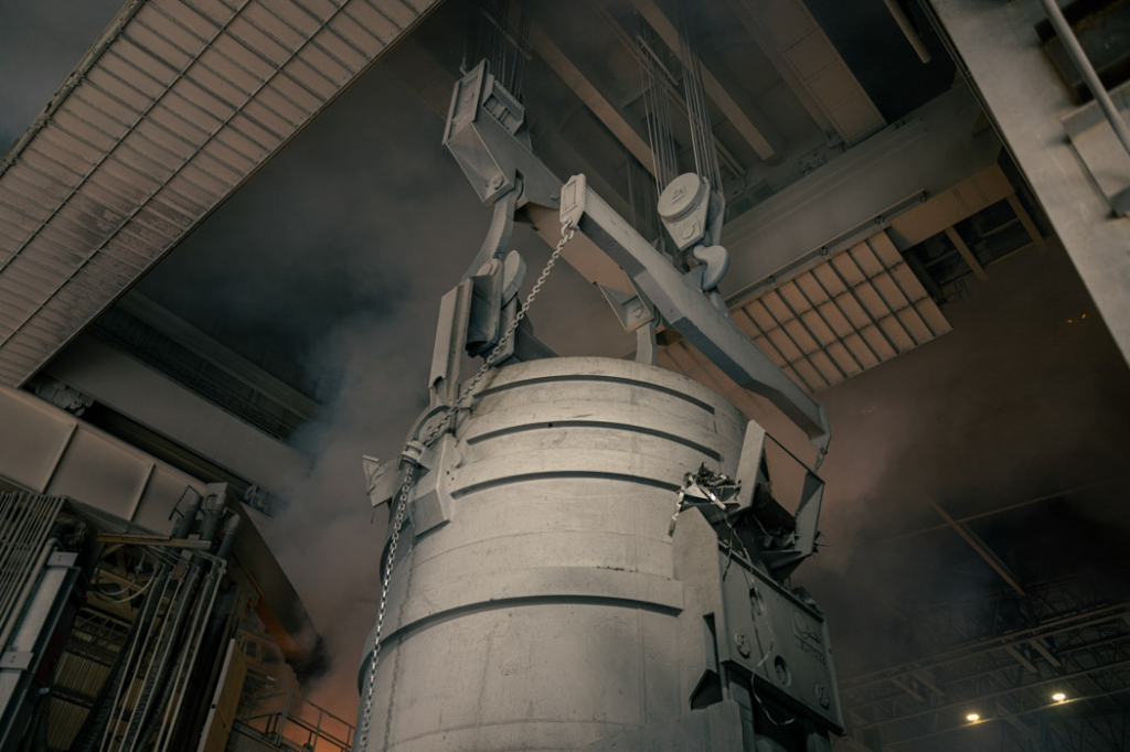 Bridge crane in melt shop transporting ladle.