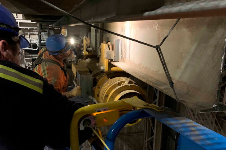 Morgan employees working on a monorail system