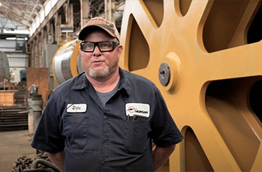 Morgan employee standing in front of a machine