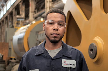 Morgan employee standing in front of a machine