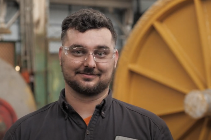 Morgan employee standing in front of a machine