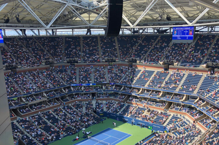 Arthur Ashe Stadium during a tennis match with the retractable roof in view