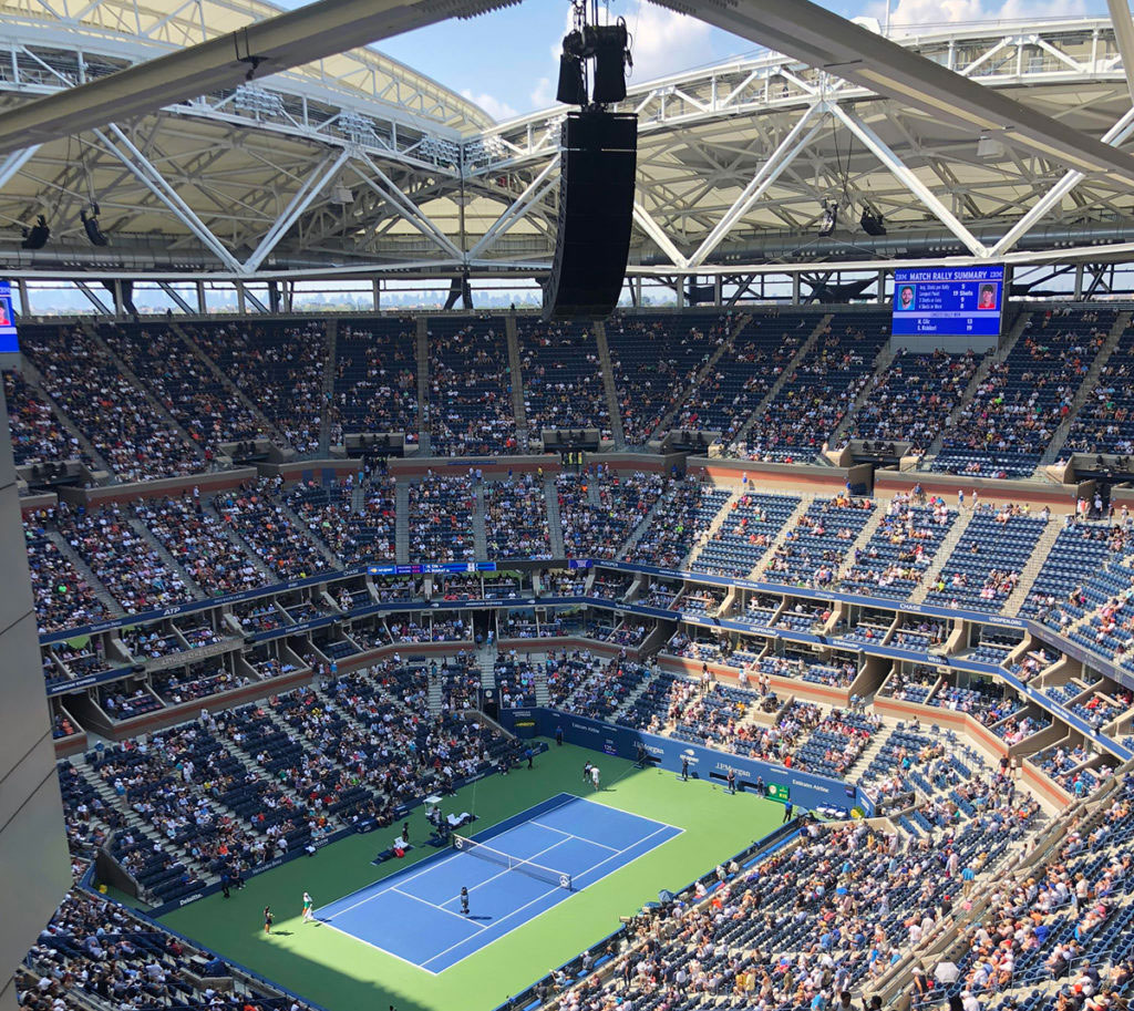 Arthur Ashe Stadium during a tennis match with the retractable roof in view