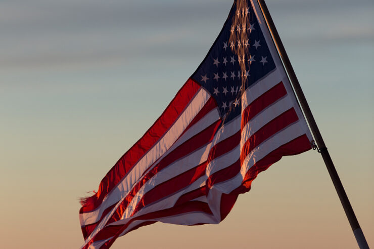 United States flag waving at sunset