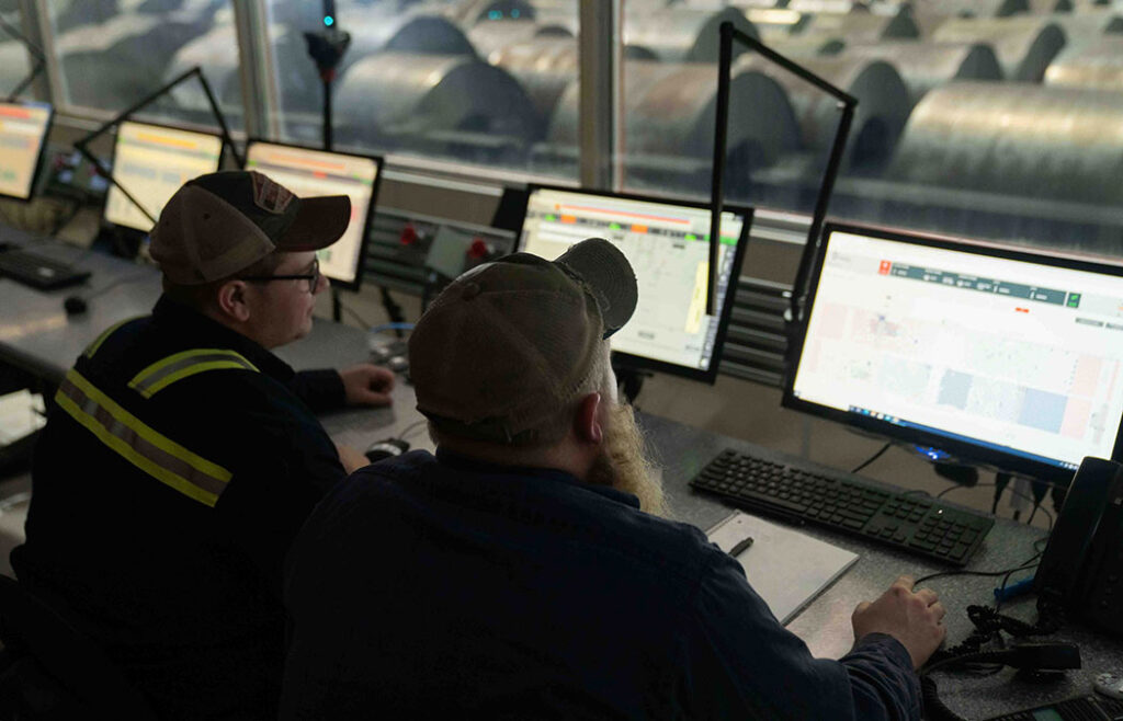 Brandon Young works with a customer during the commissioning of an automated coil storage facility.