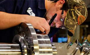 Manufacturing male Morgan employee working on a crane gear.