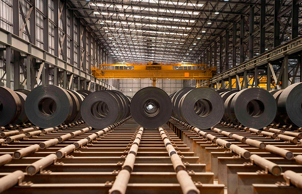 A factory full of steel coils with a Morgan crane in the background