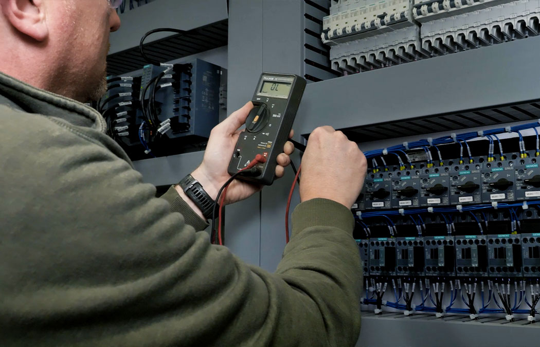 Man evaluating power supply on a crane system