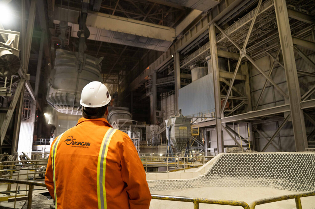 Morgan Engineering employee wearing a hard hat and viewing his work