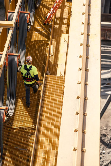 crane technician walking on bridge crane