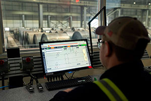 Man surveying crane automation from the control room
