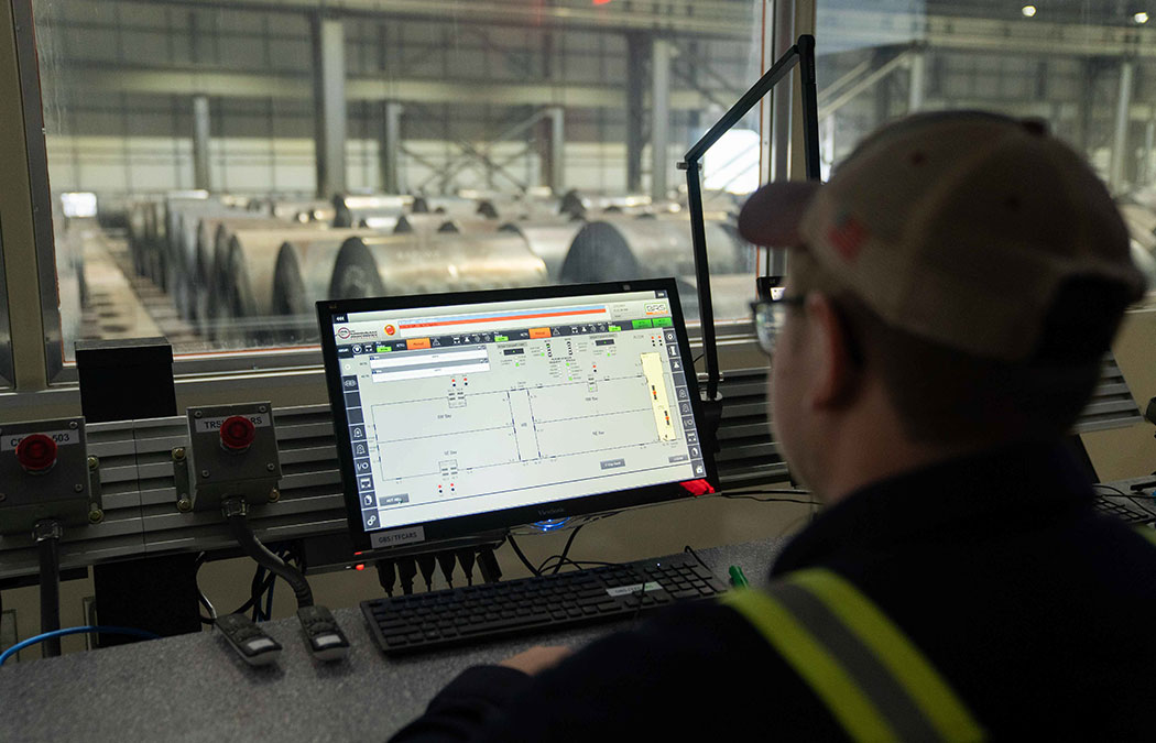 Man viewing a computer screen displaying Morgan's crane management system