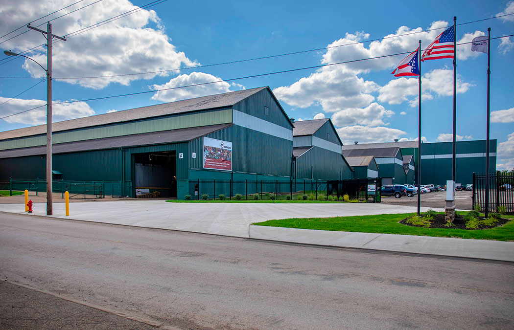 Exterior view of the Morgan facilities with flags waving in the foreground