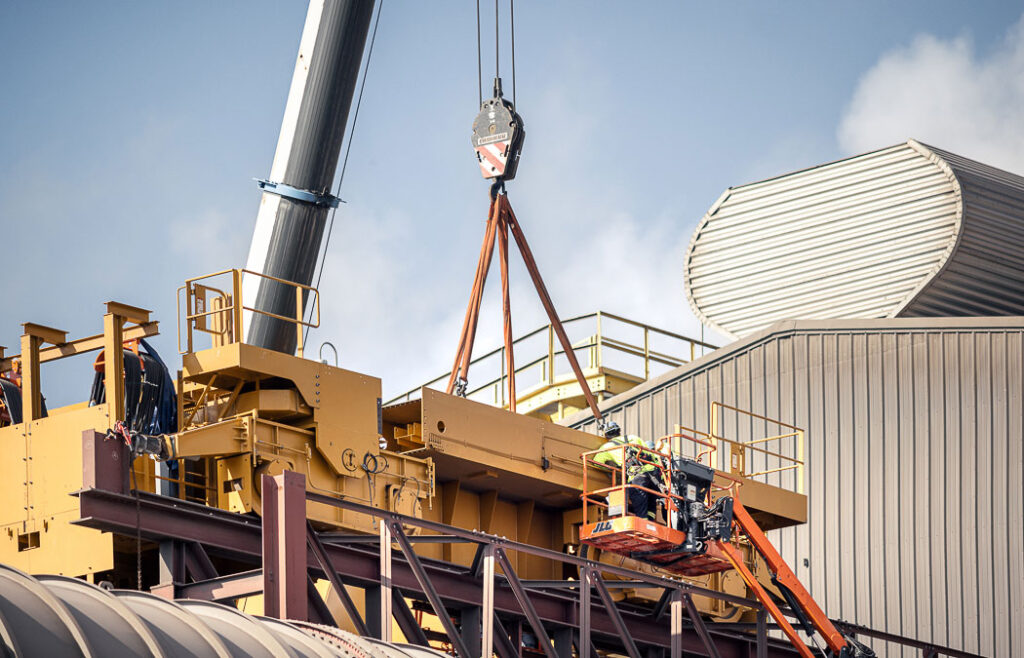 crane technician servicing an overhead crane in the field